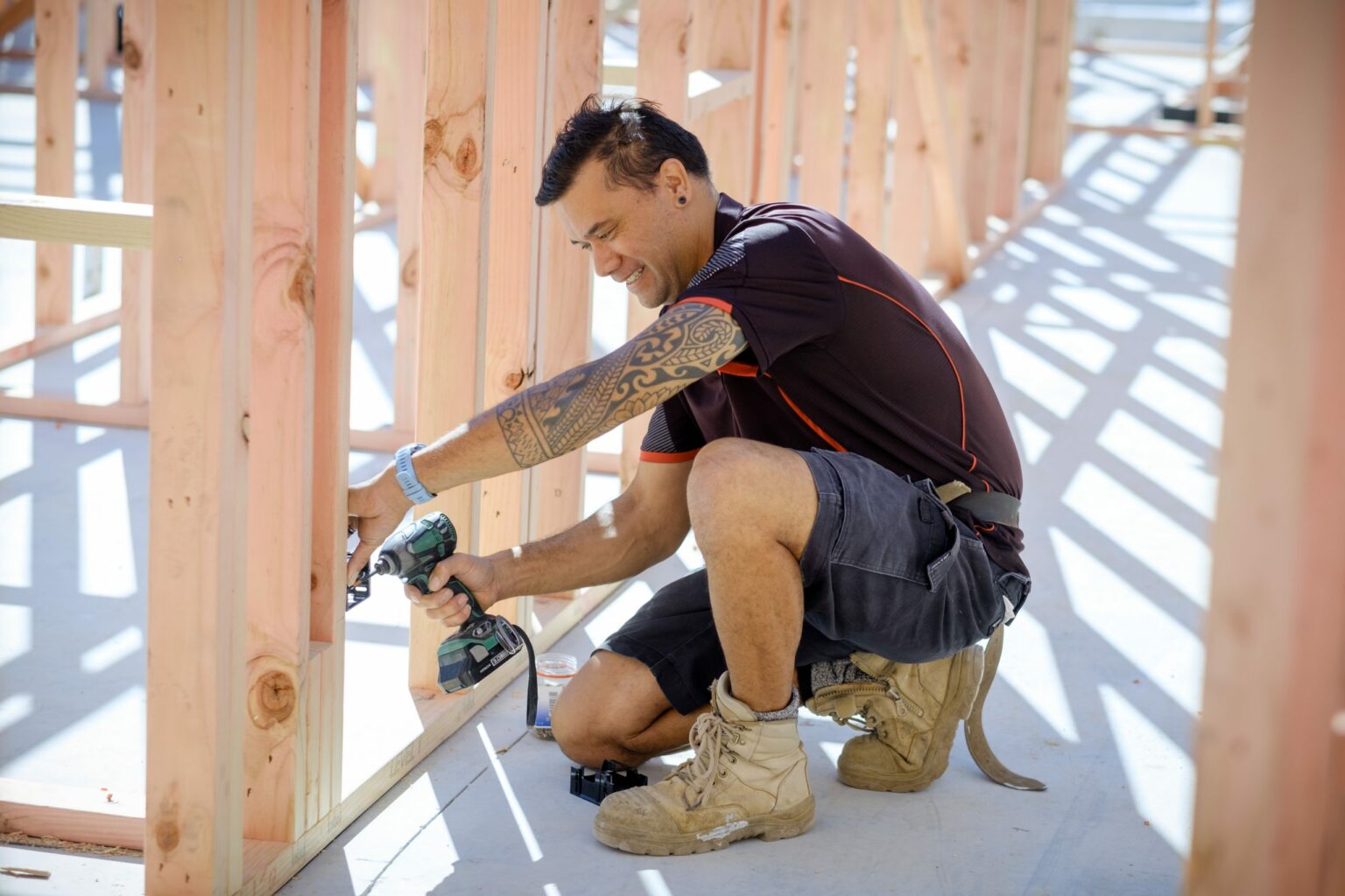 Electrician working on new home build with timber framing.